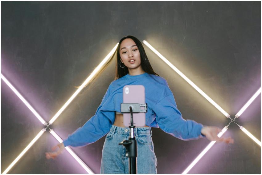 Teen influencer dances stylishly indoors, creating