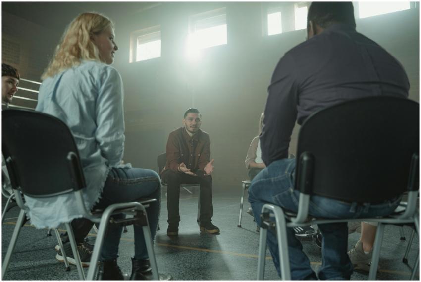 A diverse group of adults in a supportive discussi