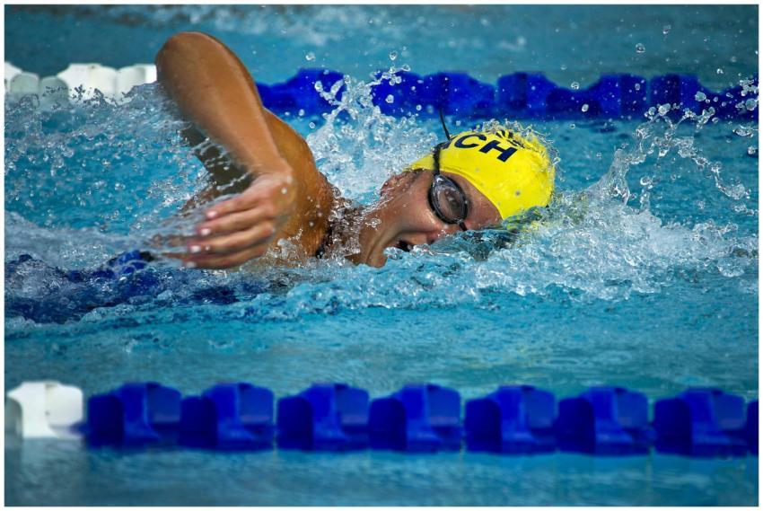 Swimmer wearing a yellow cap and goggles competing