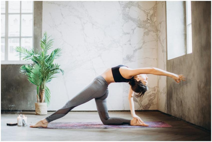 Woman performing yoga pose indoors, embracing mind