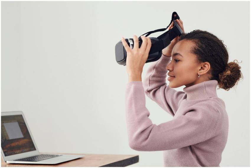 A woman puts on a VR headset in a modern room with