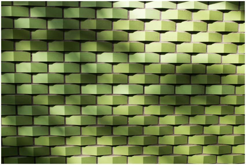 Textured green tile wall with geometric pattern an