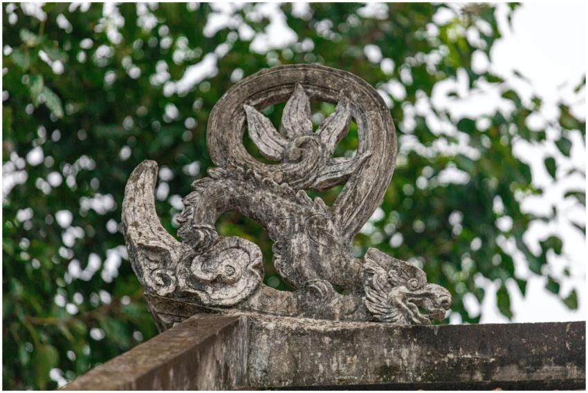 Stone dragon sculpture at a historic temple in Hà
