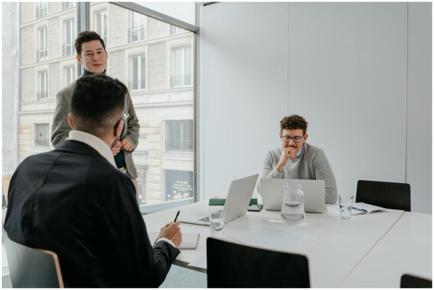 Three business professionals discuss strategies in