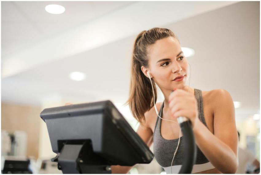 Fit woman working out on an elliptical machine ind