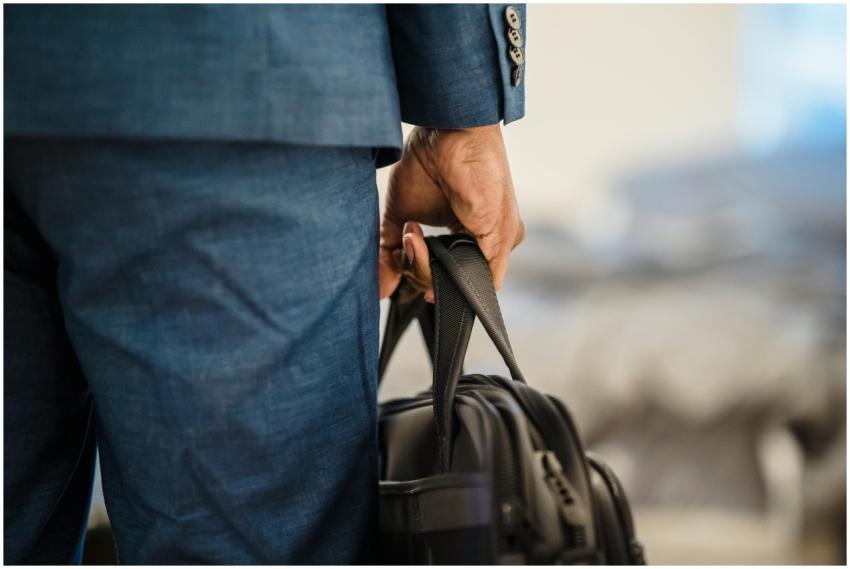 Close-up of a businessman's hand holding a briefca