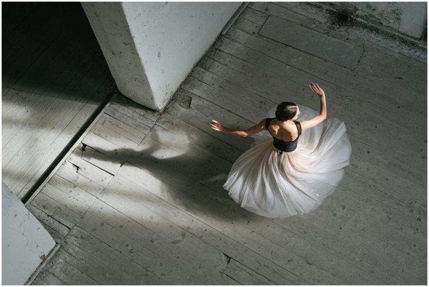 A top-view of a ballerina gracefully spinning in a