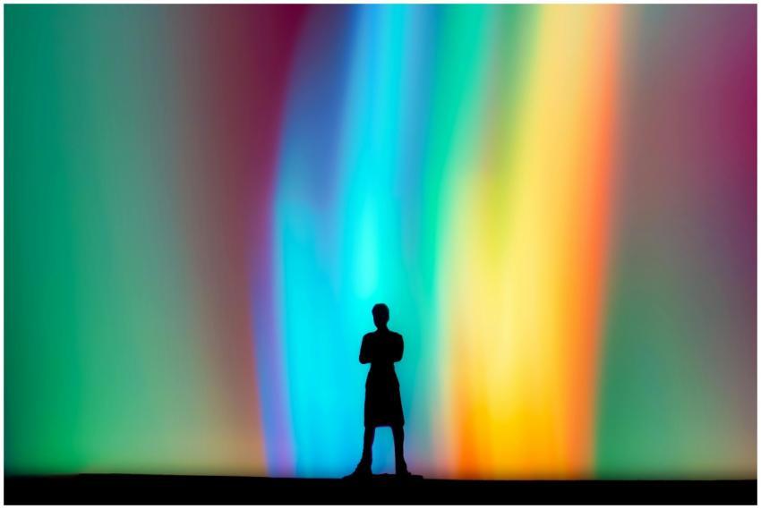 A lone silhouette of a person stands against a vib