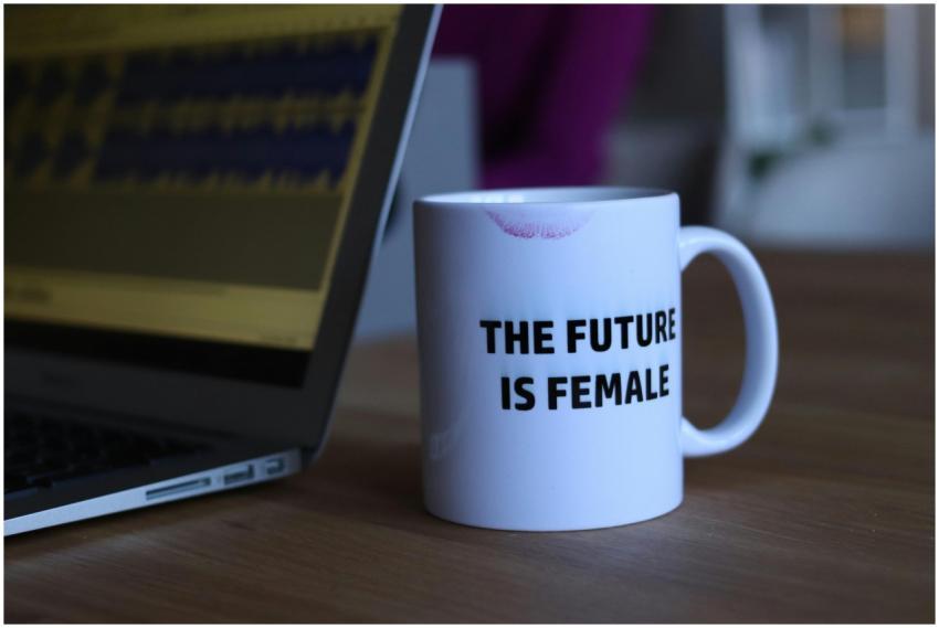 A white mug with 'The Future Is Female' beside a l