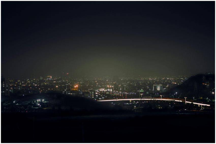 A vibrant aerial view of a city illuminated at nig