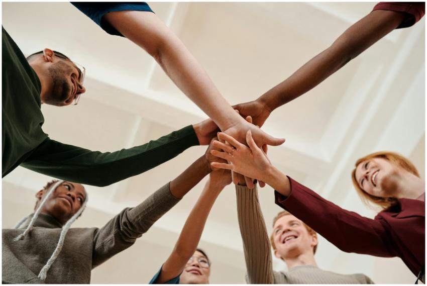 A diverse group of young adults forming a united c