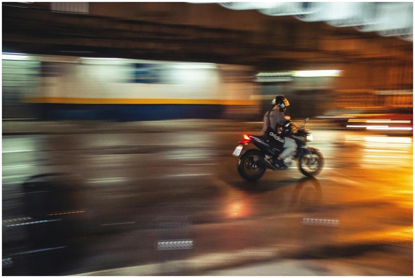 A person riding a motorcycle through a city street