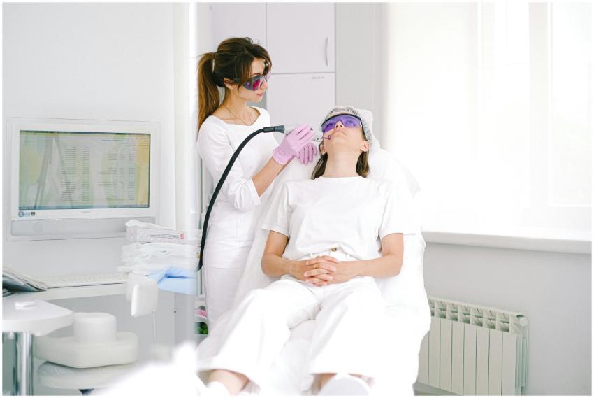Aesthetician performing laser facial treatment on