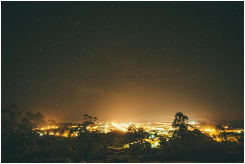 A vibrant city illuminated at night under a vast,