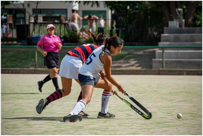 Two young girls in action during a thrilling field