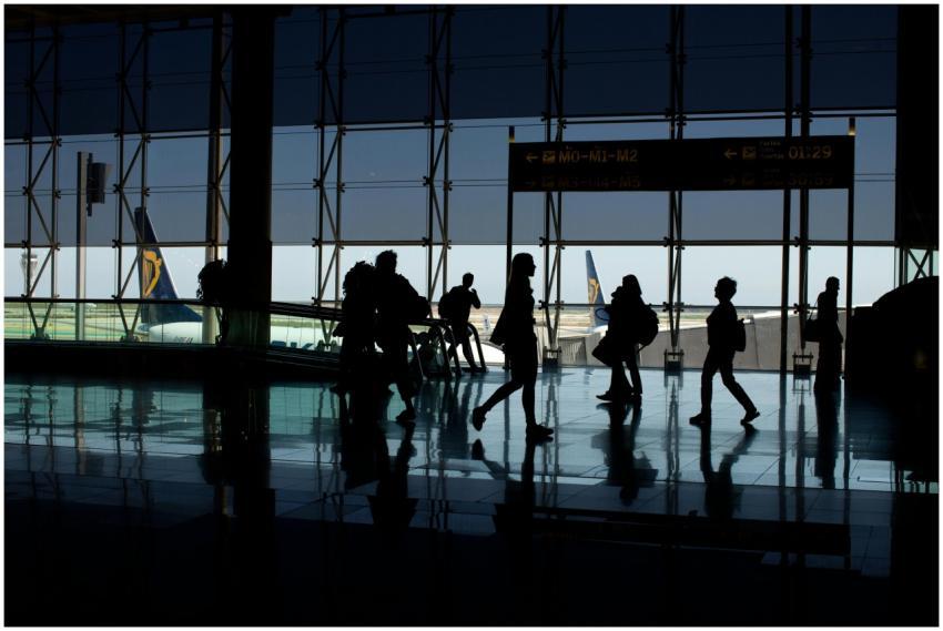 Silhouettes of people walking in an airport termin