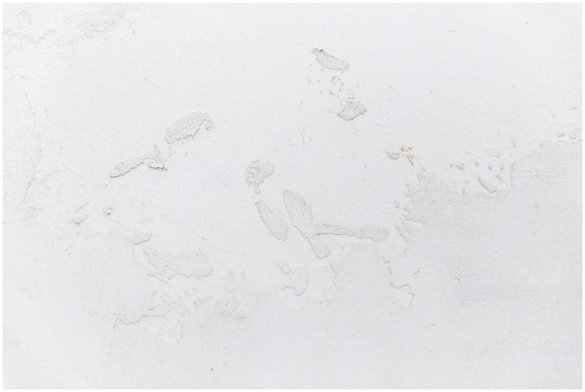 Close-up of a textured white stucco wall, ideal fo