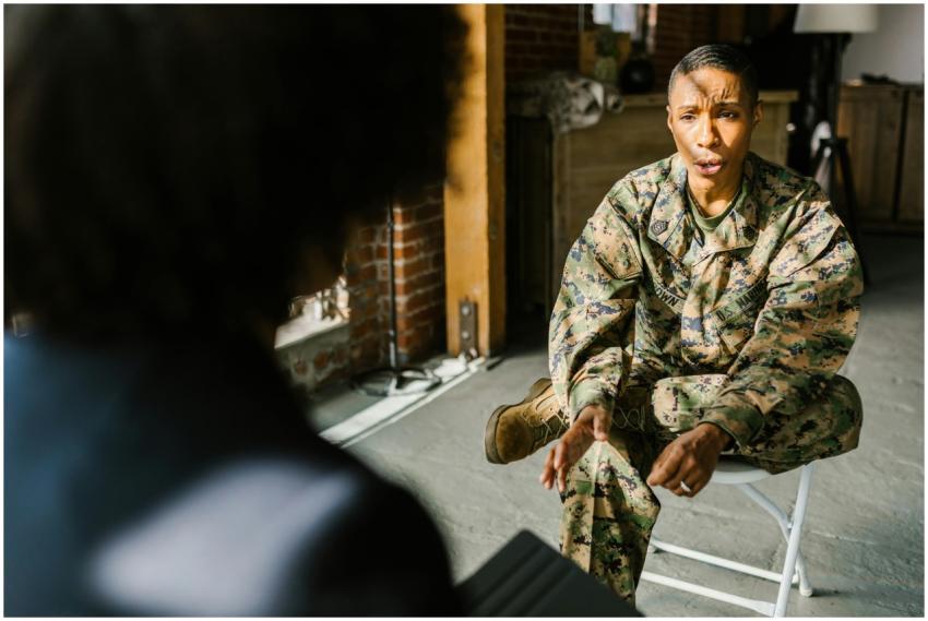 A soldier in military uniform during a therapy ses