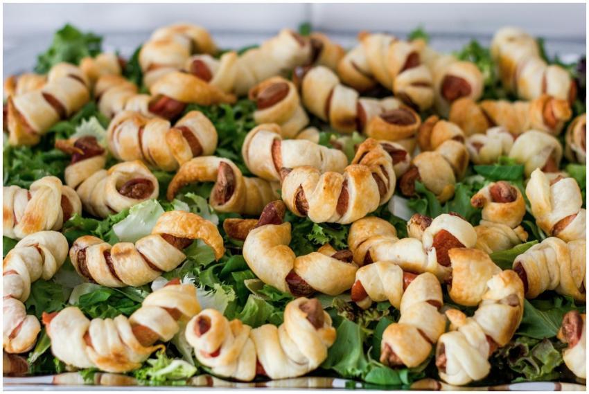 Baked puff pastry sausage rolls served on a bed of