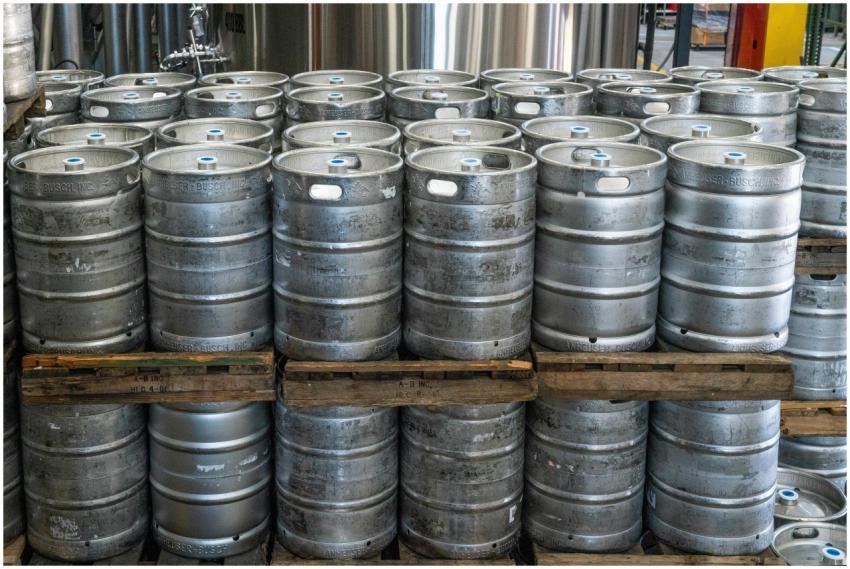 Steel kegs neatly stacked on pallets in an industr