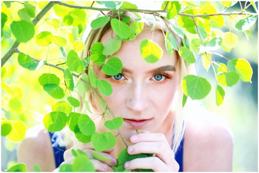 A close-up portrait of a woman with blonde hair, s