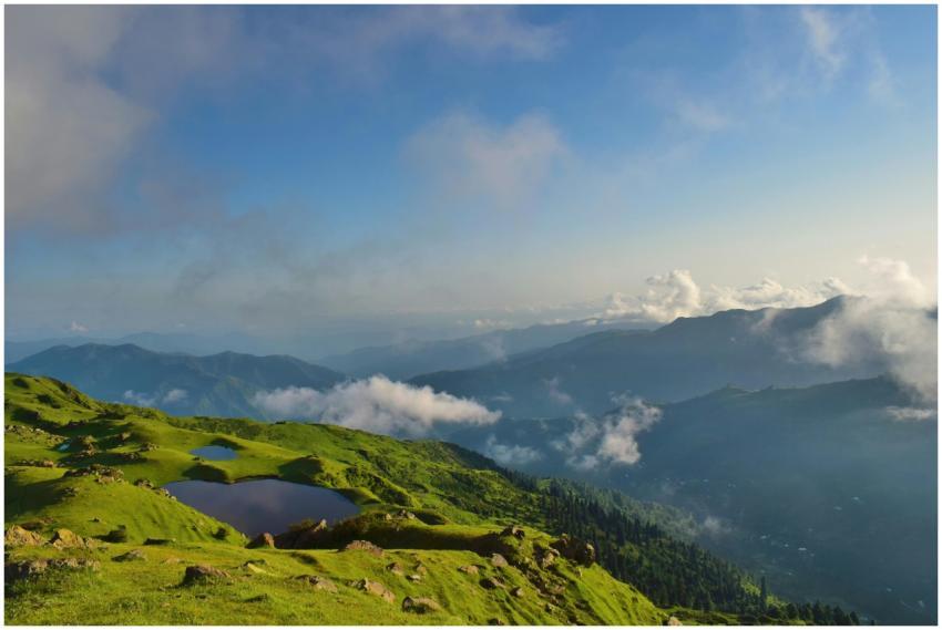 Stunning summer landscape of rolling green hills a