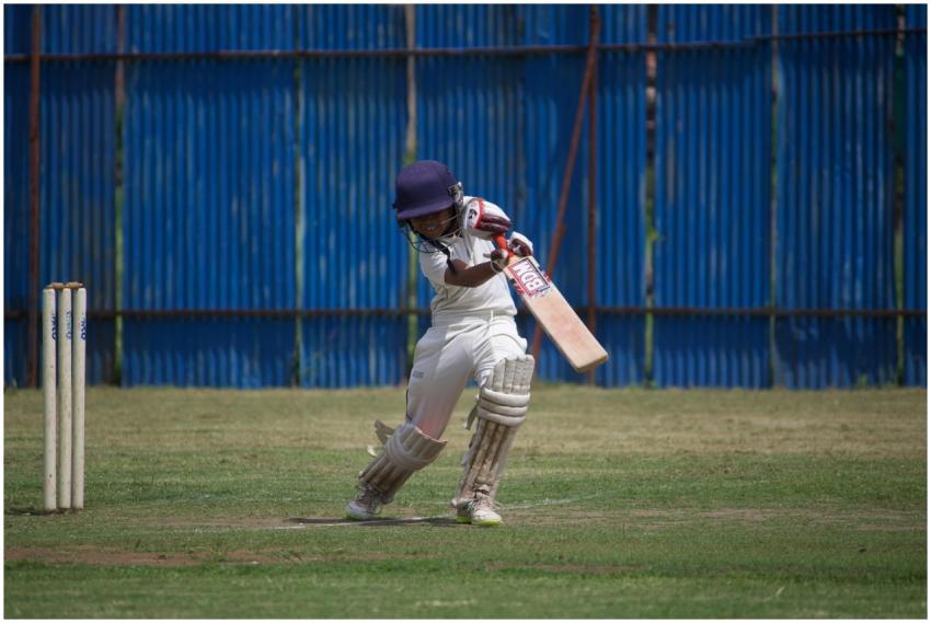 A young cricketer in action on a sunny day, playin