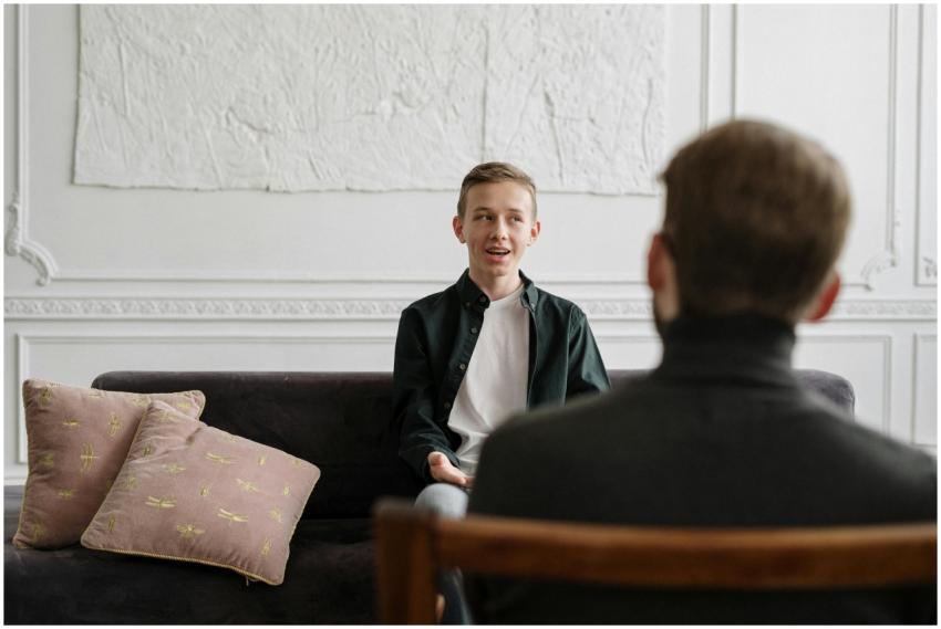 A young man engages in a therapy session with a co