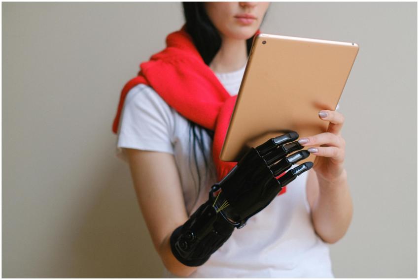A woman with a bionic prosthetic arm uses a digita