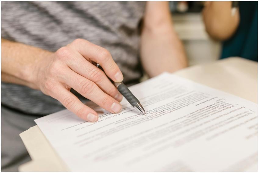 Close-up of a person's hand signing an important l