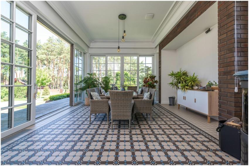 Bright sunroom with wicker chairs and patterned ti