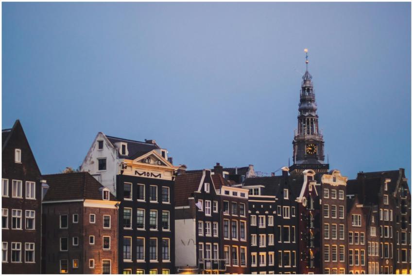 View of classic Amsterdam canal houses alongside a