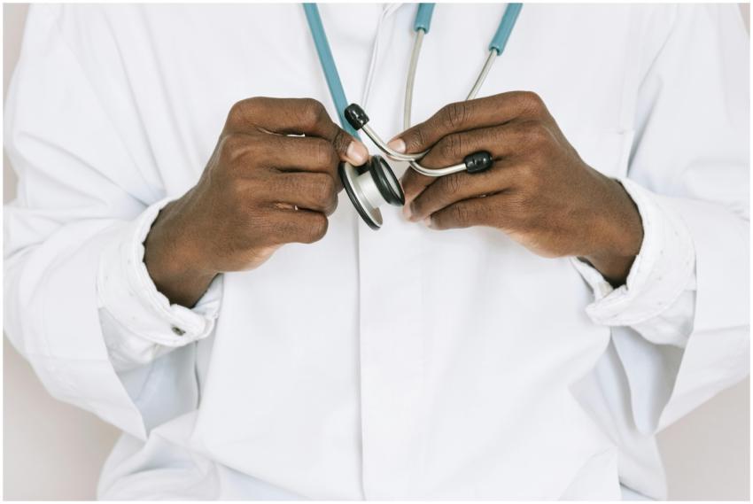 A professional doctor holding a stethoscope, focus