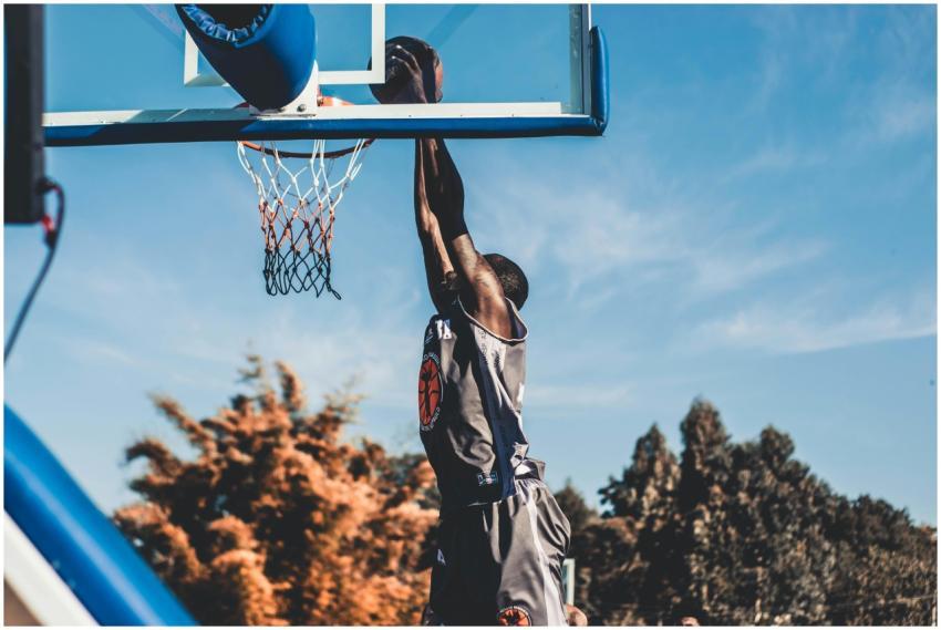 High-energy basketball dunk captured outdoors duri
