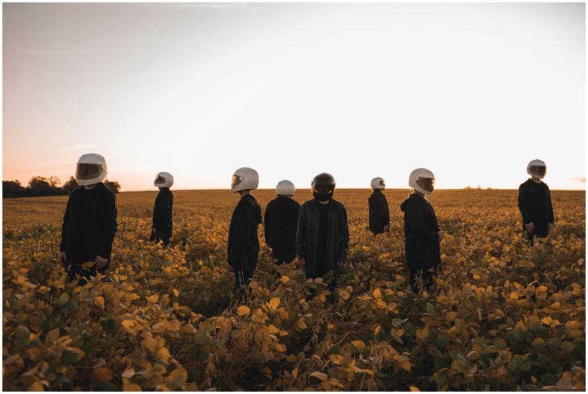 A group of people in astronaut helmets standing in
