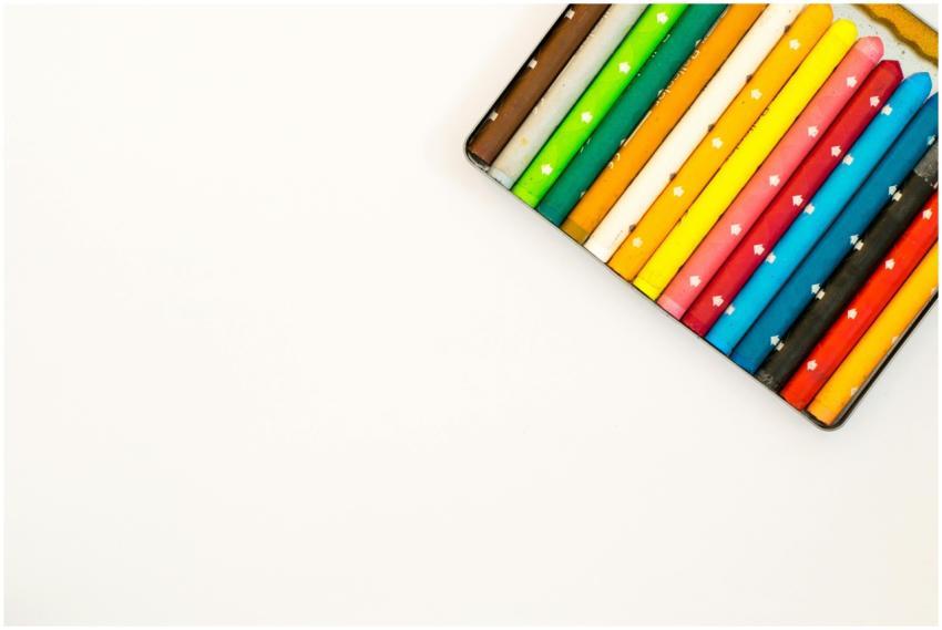 Colorful crayons arranged neatly on a white backgr