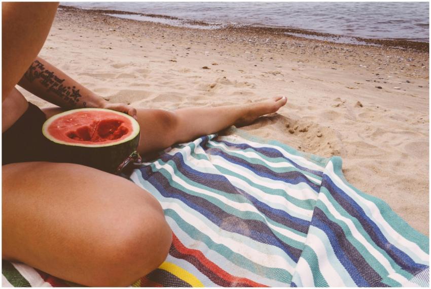 Enjoying a sunny day at the beach with watermelon