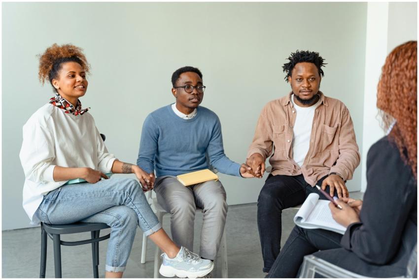 A diverse group of adults in a supportive therapy