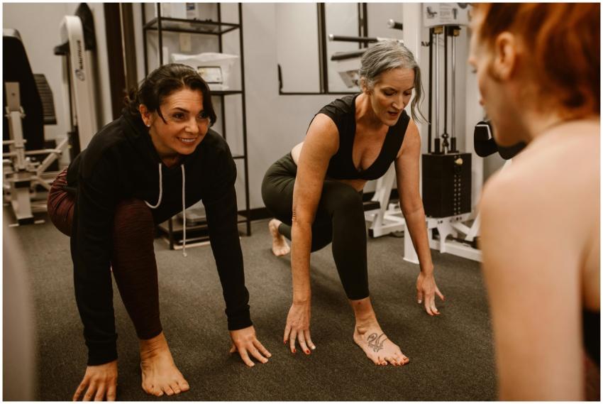 Three women engaged in a workout session in a gym,