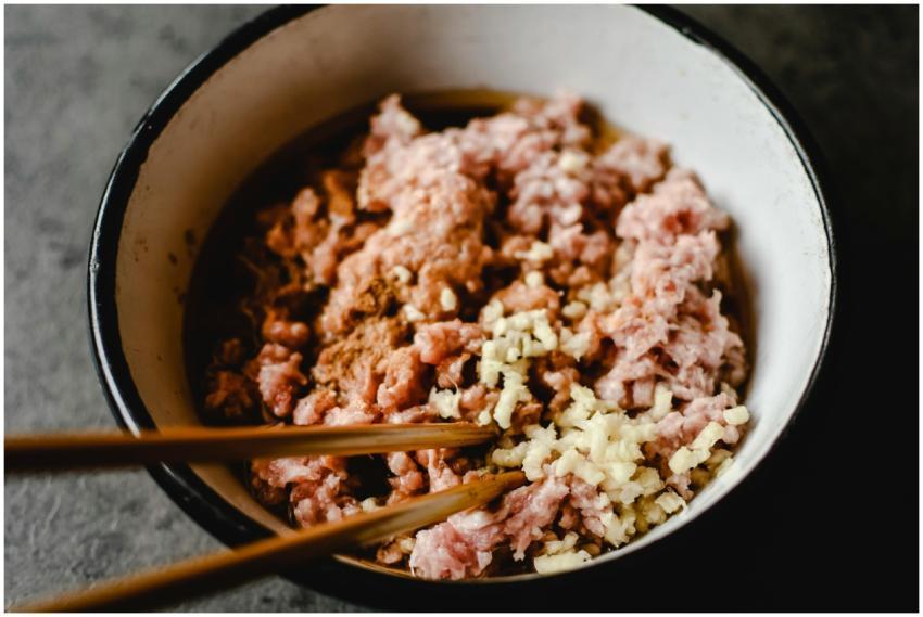 Close-up of uncooked minced pork and chopped garli