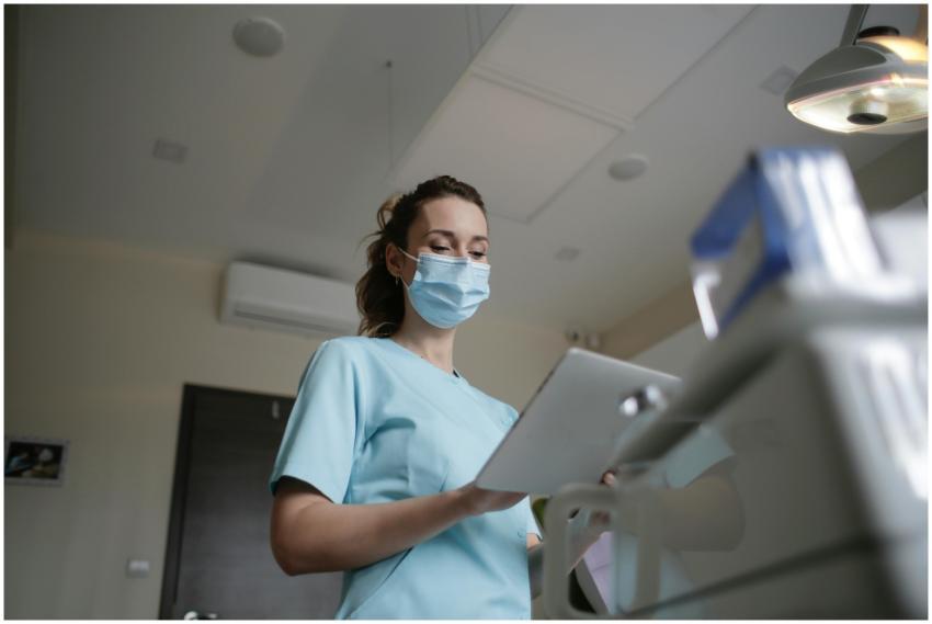 Female healthcare worker wearing a mask and holdin