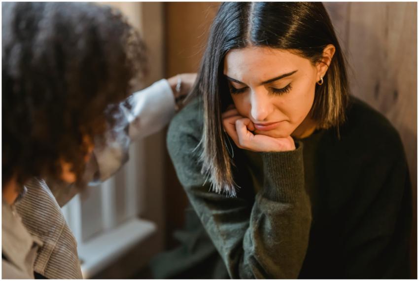 Crop woman tapping shoulder and comforting upset f
