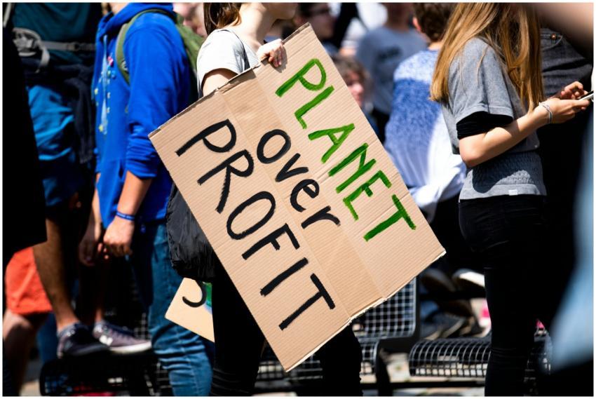 Youth climate protest with participants holding 'P