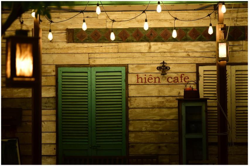 Cozy rustic cafe facade adorned with warm string l