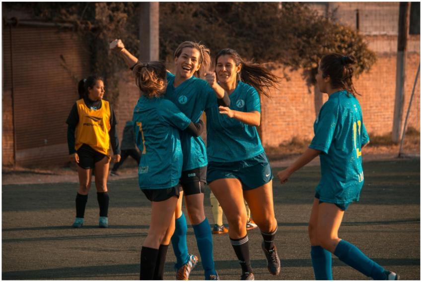 Women's soccer team celebrates a win during a game