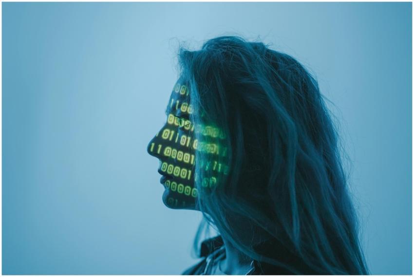 Silhouette of a woman with binary code projected o