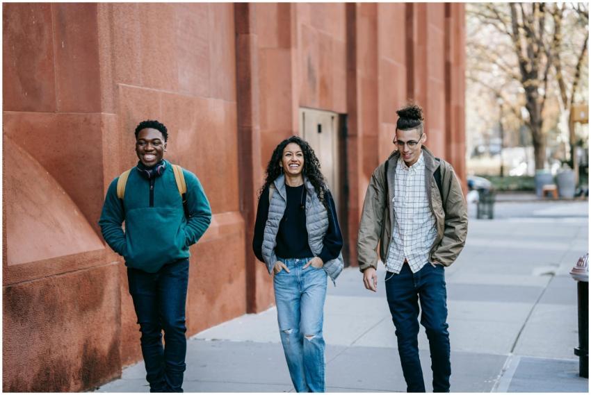 Three young friends enjoying a cheerful walk outsi