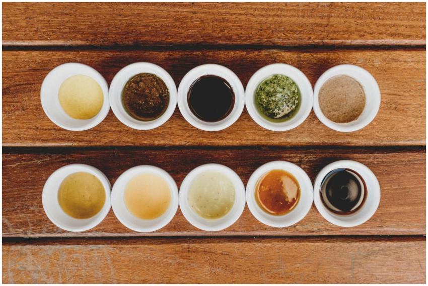 Assorted sauces displayed in bowls on a rustic woo