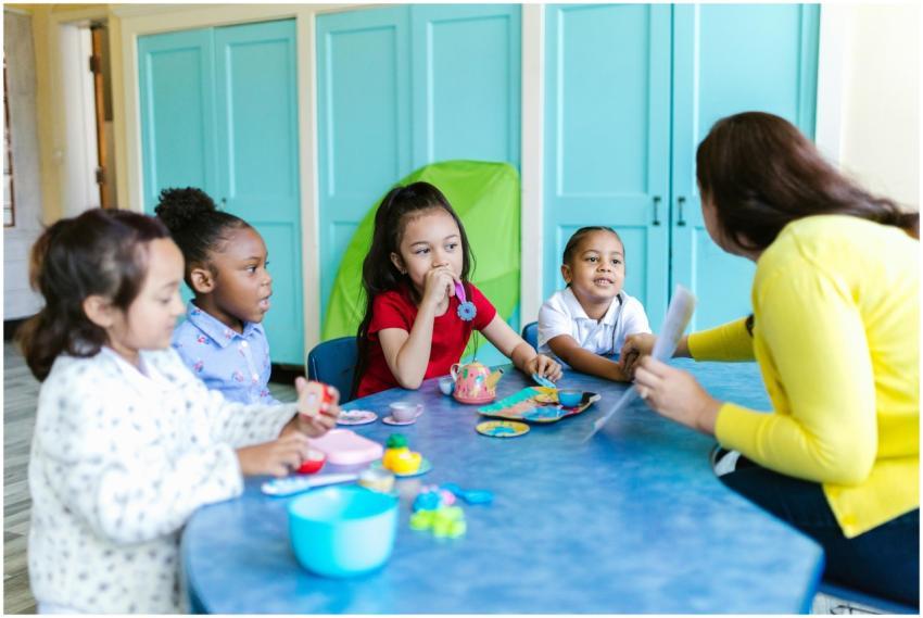 A group of preschoolers interacting with a teacher