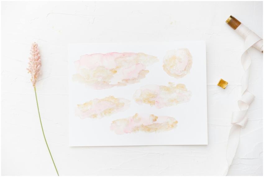 Minimalist watercolor painting on paper with a pin